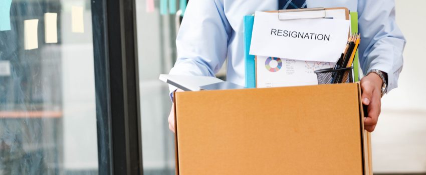 Professional Man Exiting Office with Personal Belongings and Resignation Letter, Embarking on a New Path After Job Resignation