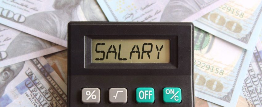 Top view image of calculator with text SALARY and money. Business and finance concept